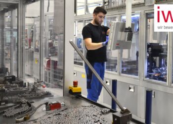 Mann arbeitet an einer Maschine in der iwis Produktion